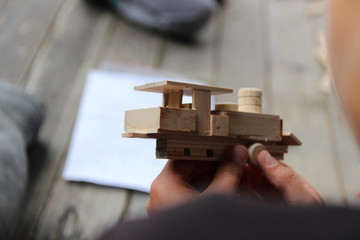 Child's hand, fold and stick a wooden toy