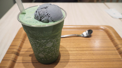 Matcha latte with black sesame ice cream float ,In japan dessert shop.