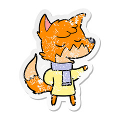 distressed sticker of a friendly cartoon fox in winter clothes