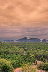 The panoramic background of the surrounding scenery (mountains, sea, islands, clouds, sky) and a wooden chair to sit and enjoy the view, is the beauty of nature during travel.