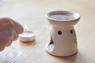 Aroma lamp with essential oil, burning candle, aromatherapy