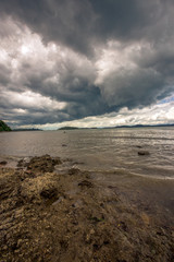 The background of a cloudy sky, colorful like a storm, and rain later, with blurring of wind and sea together, is a phenomenon that occurs naturally.