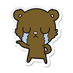 sticker of a crying cartoon bear