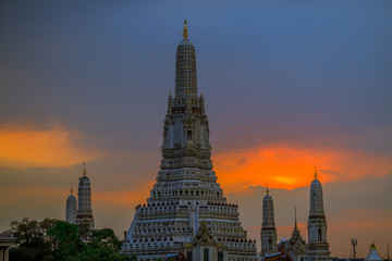 Fototapeta premium Twilight wallpaper in the evening,the sun going back to the horizon,Wat Arun Ratchawaramaram is a temple along the ChaoPhraya River is an important place and a beautiful tourist destination in Bangkok