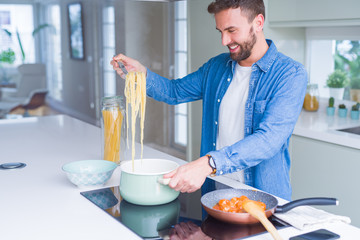 Handsome man cooking pasta at home