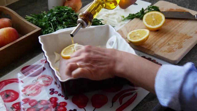 preparation of fresh fish, raw cod fillets with addition of herbs and lemon