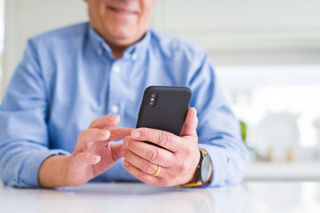 Close up of man hands using smartphone and smiling confident