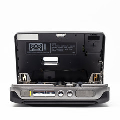 Vintage audio player. Old fashioned portable cassette player, cult object, icon and symbol of the 80s and 90s. Isolated on white background. Open door.