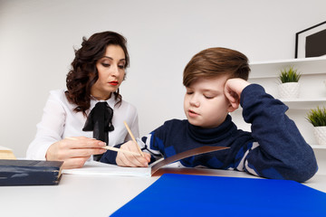 Young teacher trying to explain information to the boy. Educating together
