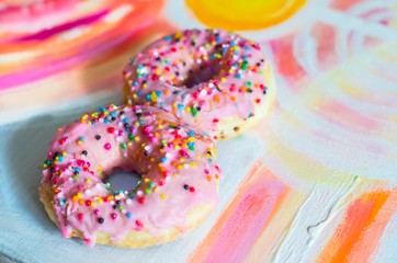 Pink Donuts in the form of 8 in a picturesque background.