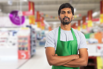 Supermarket employee portrait with crossed arms. - obrazy, fototapety, plakaty