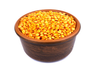 Red lentils in plate isolated on white background