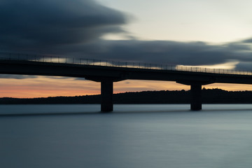 Fototapeta na wymiar Nice sunset after a viaduct crossing over a lake
