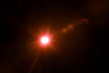 abstract lens flare red light over black background - Powered by Adobe