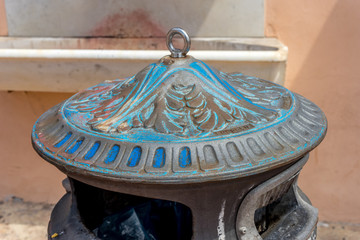 Blue and brown top of a garbage bin