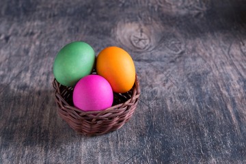 Easter eggs in basket on a wooden 