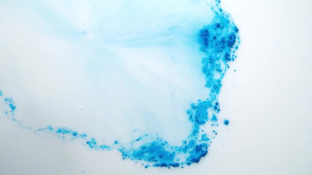 Close-up of paint blurred in water. Paint is washed away on surface of water from touch of cotton swab. Technique of drawing blurred paints on water