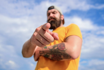 Man bearded muscular brutal hipster outdoors sky background. Masculinity and brutality. Lumbersexual tattooed well groomed hipster. Hipster with mustache and long beard. Talking to you. Hey you