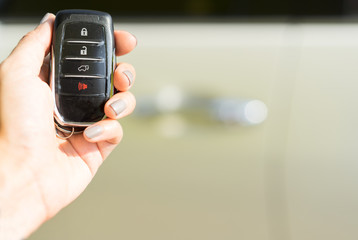 Hand holding remote car key.