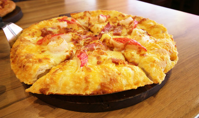 pizza served at restaurant on handled wooden board