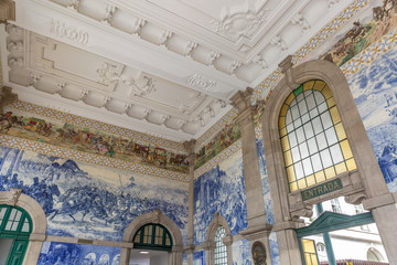 Painted ceramic tileworks on the walls of Main hall of Sao Bento Railway Station in Porto