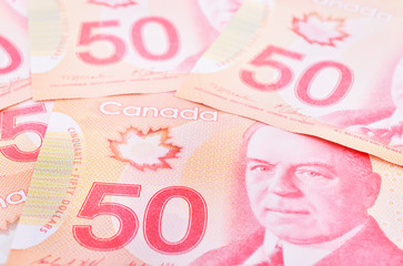Canadian $50 dollar banknotes. The notes are dominantly red in colour