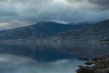 Beautiful reflections of clouds and mountains in the water of a lake