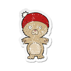 retro distressed sticker of a cartoon cute teddy bear in hat