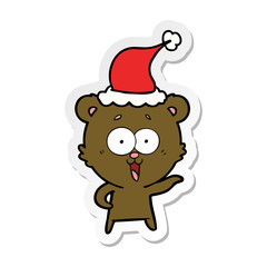 laughing teddy  bear sticker cartoon of a wearing santa hat