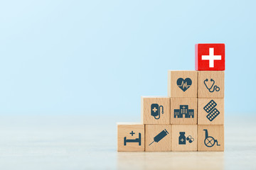 Health Insurance Concept,hand arranging wood block stacking with icon healthcare medical.