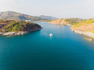 Aerial view of single yacht in azure sea.