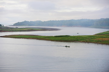 Small boats for transporting tourists in Srinakarin Dam, Thailand View of floating houses in dams and tourist boats