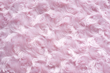 .background of pink faux fur with curls..