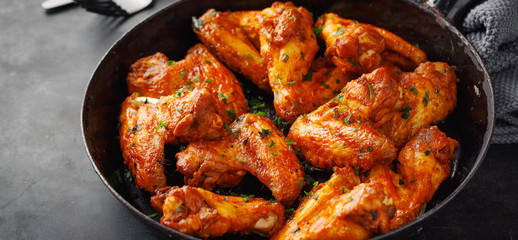 Chicken wings grilled in sauce on pan