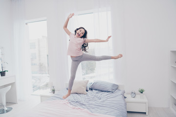 Full length body size view photo funky careless she her little girl jumping high on bed ballet figures flexible playful wear home t-shirt pants comfortable apartments flat bright light colored room