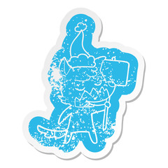 friendly cartoon distressed sticker of a fox wearing santa hat