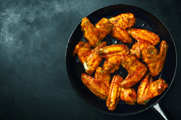 Chicken wings grilled in sauce on pan