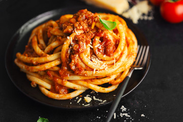 Tasty pasta bolognese with cheese and basil