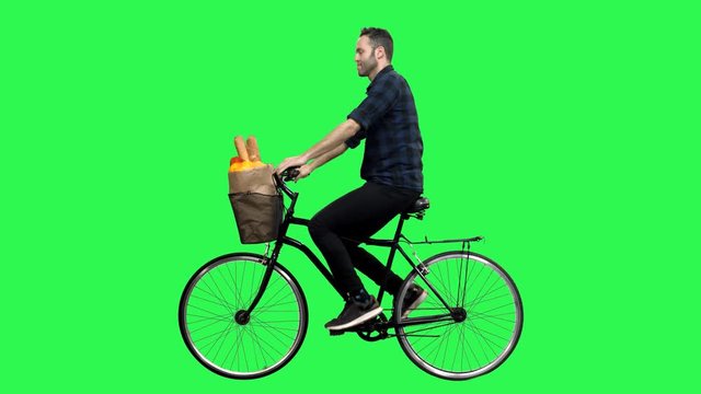 Reactions to the camera by a man riding a bicycle over a green screen. No motion blur for optimal keying.