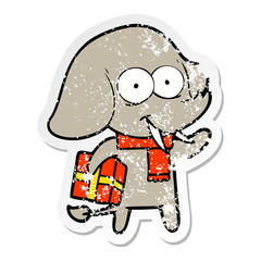 distressed sticker of a happy cartoon elephant with present