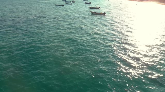 Small panga style dive boats on the ocean near shore in Tulum, Mexico.