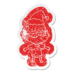 cartoon distressed sticker of a boy wearing sunglasses wearing santa hat