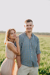 Young couple in love in summer in field.Couple hugging outdoor.