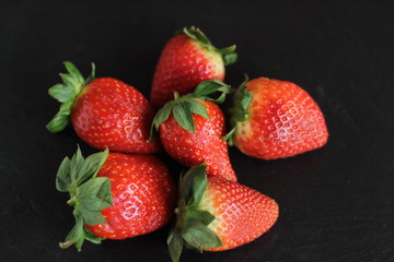 fresh red tasty sweet strawberry, on black background 