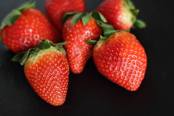 fresh red tasty sweet strawberry, on black background 