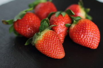 fresh red tasty sweet strawberry, on black background 