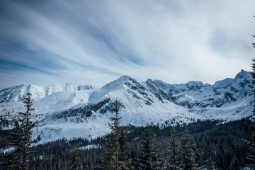 Landscape view of mountain tops in the Zakopane and in Poland area covered with fresh snow during a sunny day