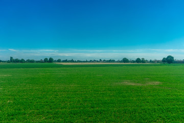 Italy,La Spezia to Kasltelruth train, a large green field with trees in the background