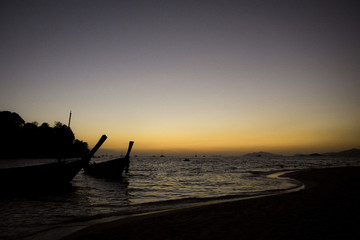 silhouette of a boat at sunset, summer beach landscape