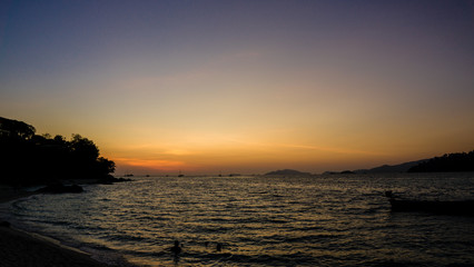 Fototapeta na wymiar silhouette of a boat at sunset, summer beach landscape